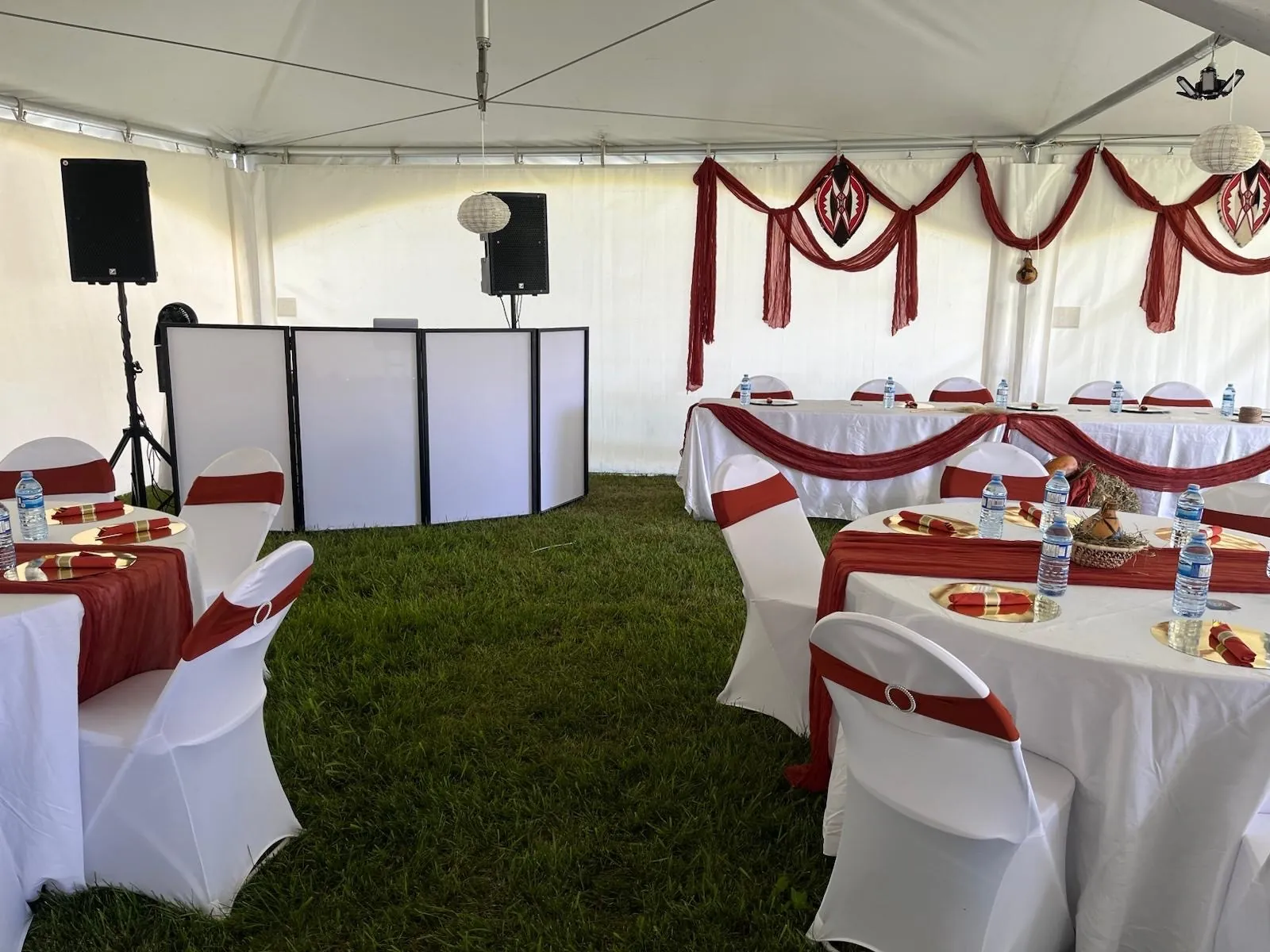 Rubicon's white DJ facade and speakers set up inside a decorated event tent